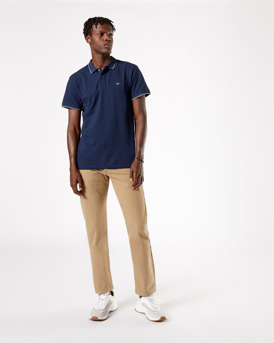 Front view of model wearing New British Khaki Men's Slim Fit Smart 360 Flex Alpha Khaki Pants.