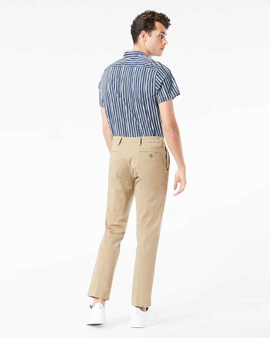 Back view of model wearing New British Khaki Men's Slim Fit Smart 360 Flex Workday Khaki Pants.