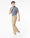 Side view of model wearing New British Khaki Men's Slim Fit Smart 360 Flex Workday Khaki Pants.