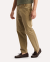 Side view of model wearing New British Khaki Original Chino Pants, Relaxed Taper Fit.