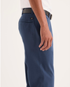 Side view of model wearing Ocean Blue Alpha Chino Pants, Slim Fit.