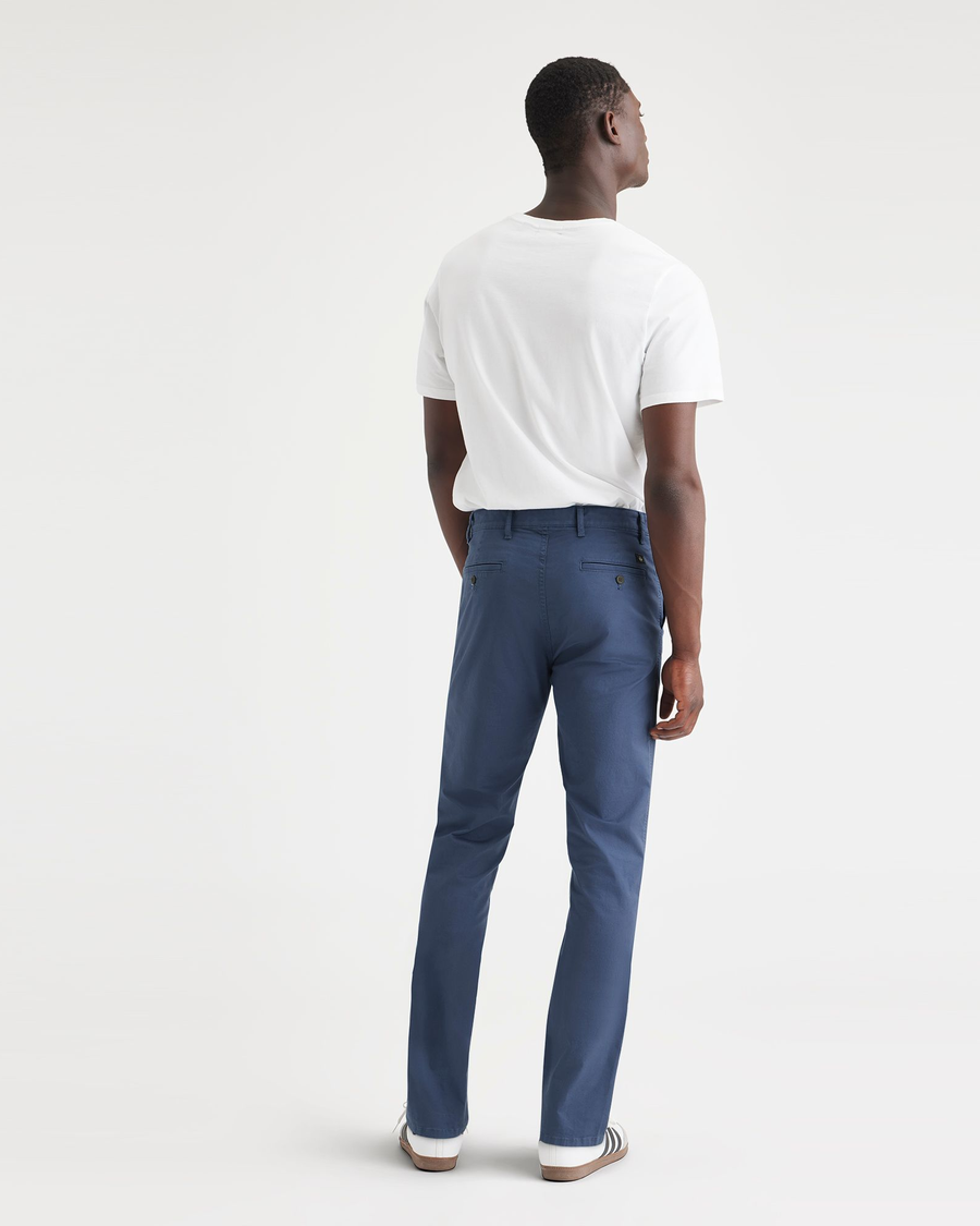 Back view of model wearing Ocean Blue Men's Slim Fit Original Chino Pants.