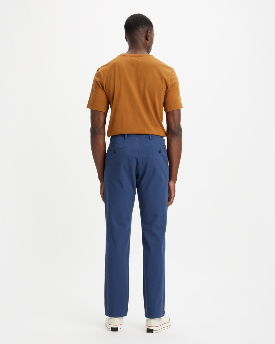 Back view of model wearing Ocean Blue Men's Slim Fit Smart 360 Flex Alpha Chino Pants.