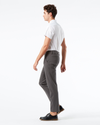 Side view of model wearing Storm Workday Khakis, Slim Fit.