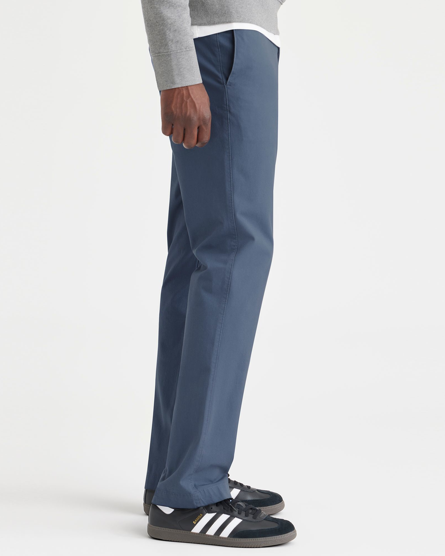 Side view of model wearing Vintage Indigo Men's Slim Fit Smart 360 Flex California Chino Pants.