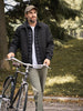 Man with a bicycle in a park setting wearing Dockers Go.